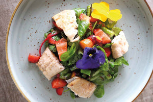 Trout on wild herb salad with green asparagus and strawberries 